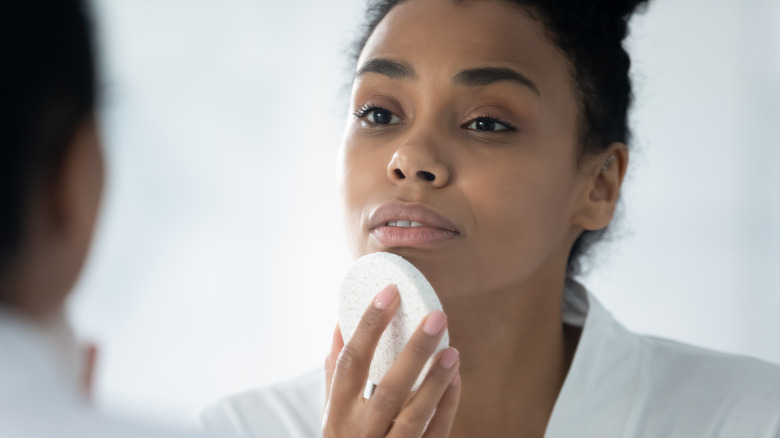 woman washing her face