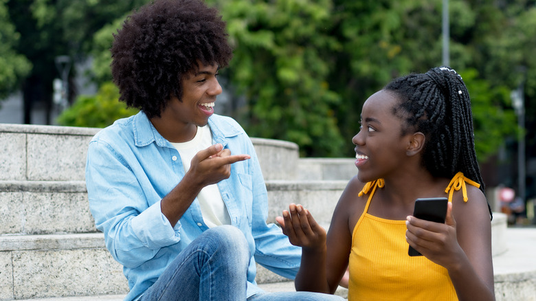 Couple sitting on outdoor stairs and smiling