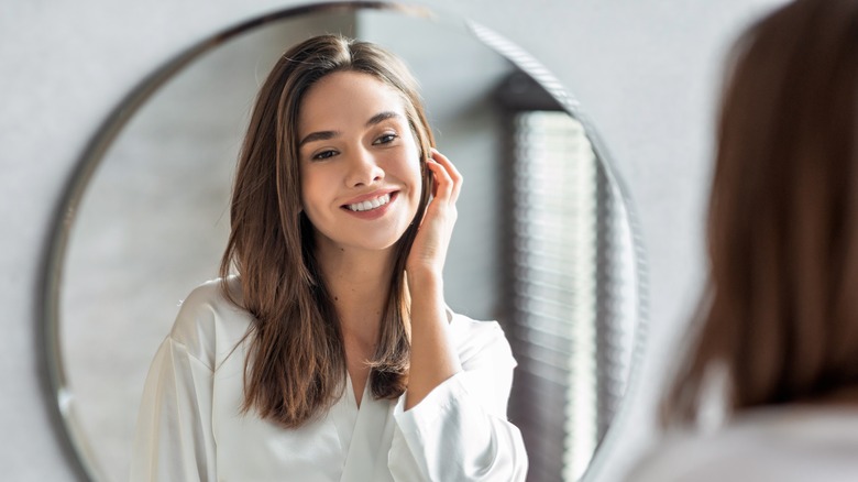 woman looking in mirror