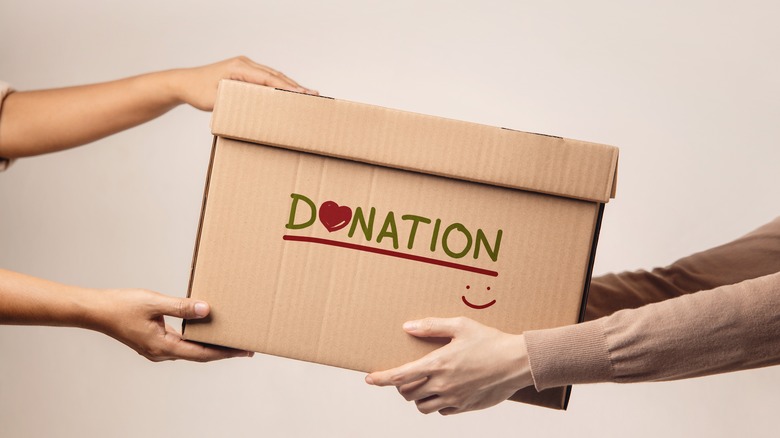 Person holding donation box