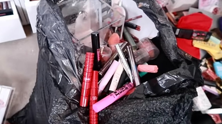 Makeup in black trash bag