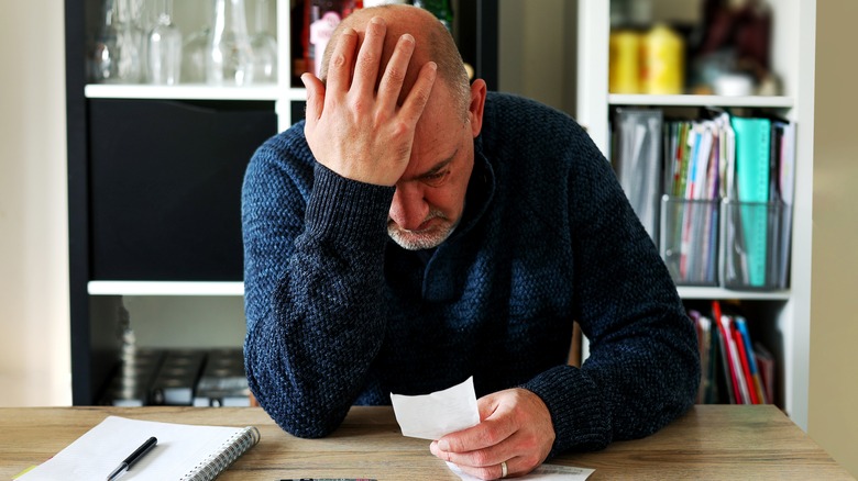 Man looking at papers on desk