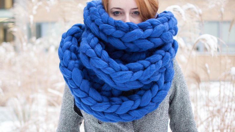 Girl wearing large scarf across the face.