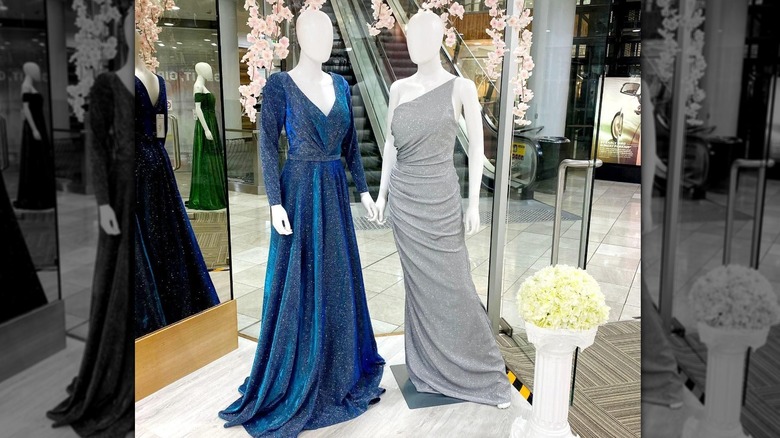 Two mannequins wearing full length gowns