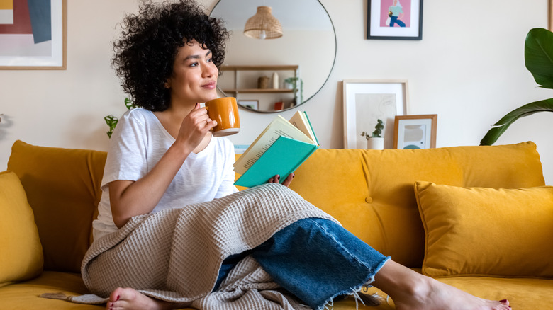 Woman relaxing with coffee and a book