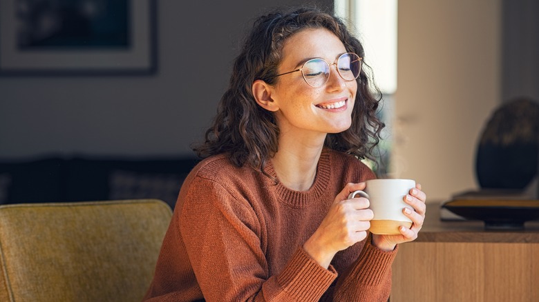 Woman smiling with cup of coffee