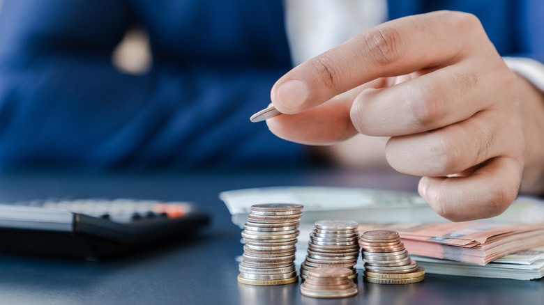 Person with coins and calculator