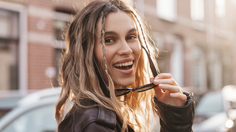 blond woman with plaits smiling 