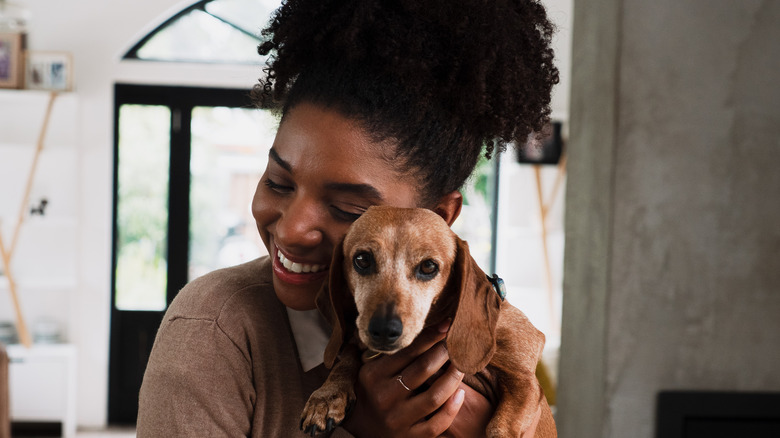 woman holding dog