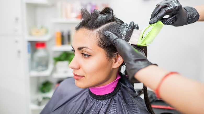 Caucasian woman getting keratin treatment in hair salon