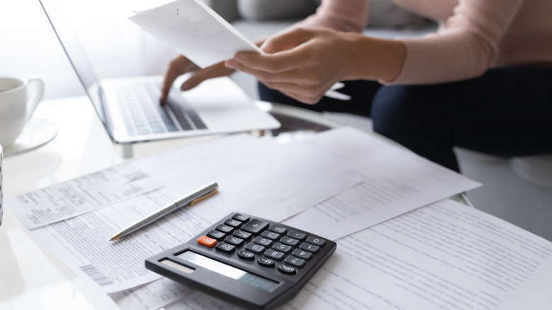 person at a computer paying bills