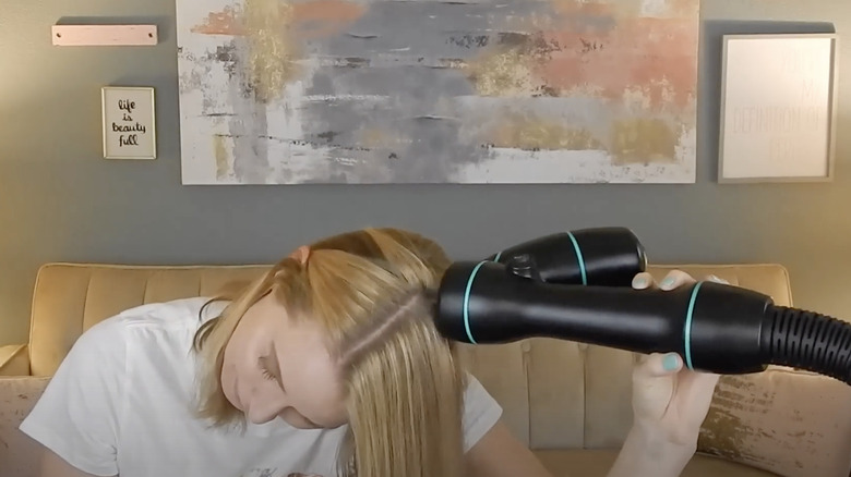 woman vacuuming her hair