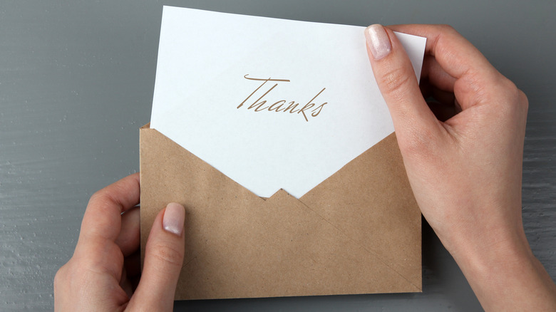 person opening thank you card 