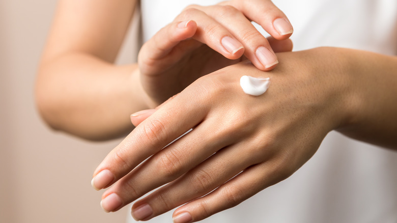 person using hand cream