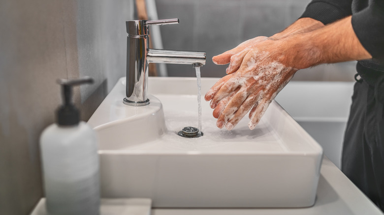 person washing hands 