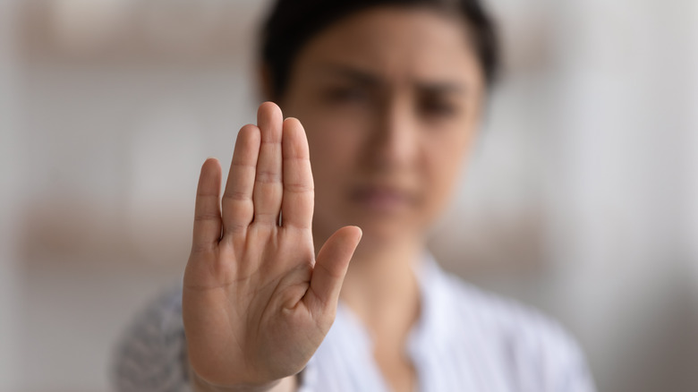 woman rejecting with hand raised