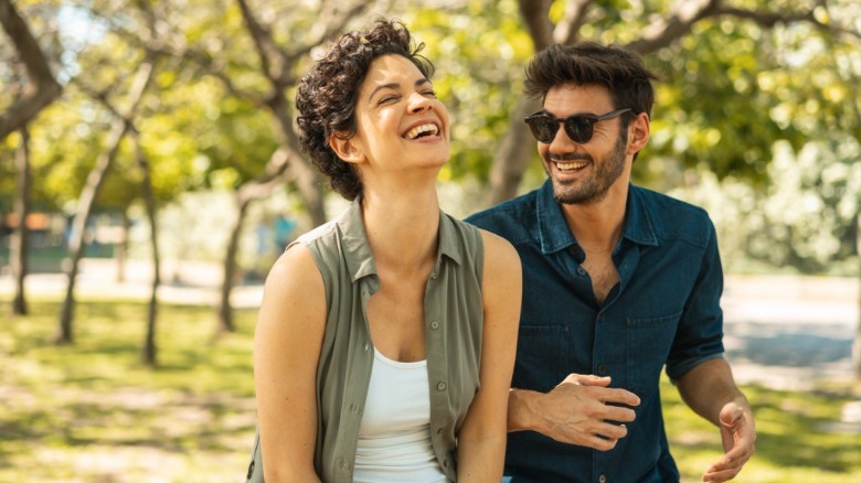 Man and woman laughing outside