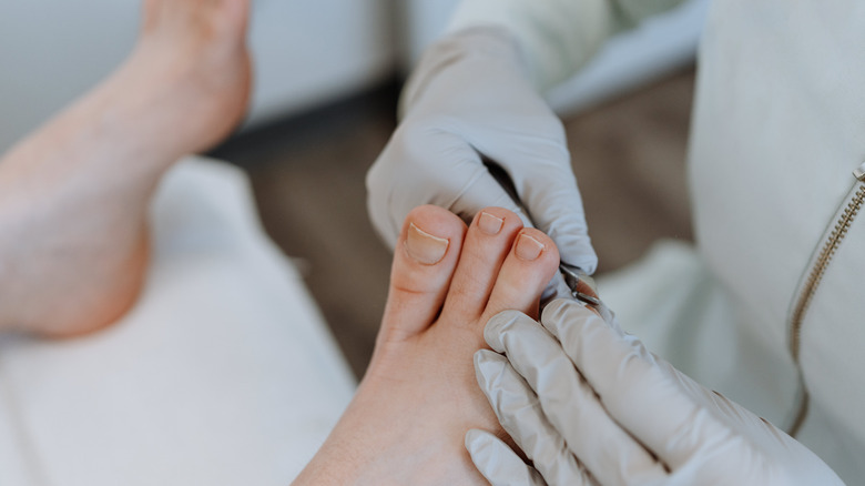 podiatrist trimming nails on feet