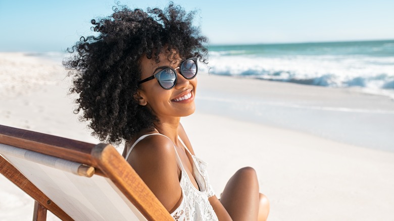 woman on beach smiling 