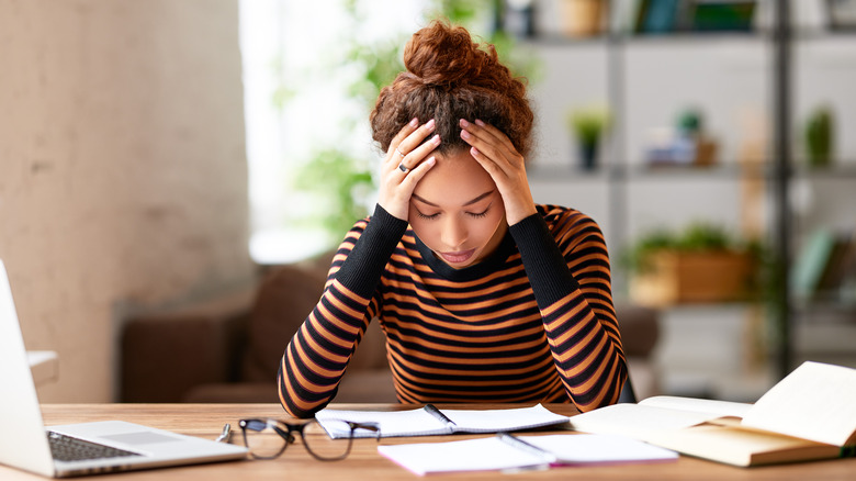 downcast woman at desk