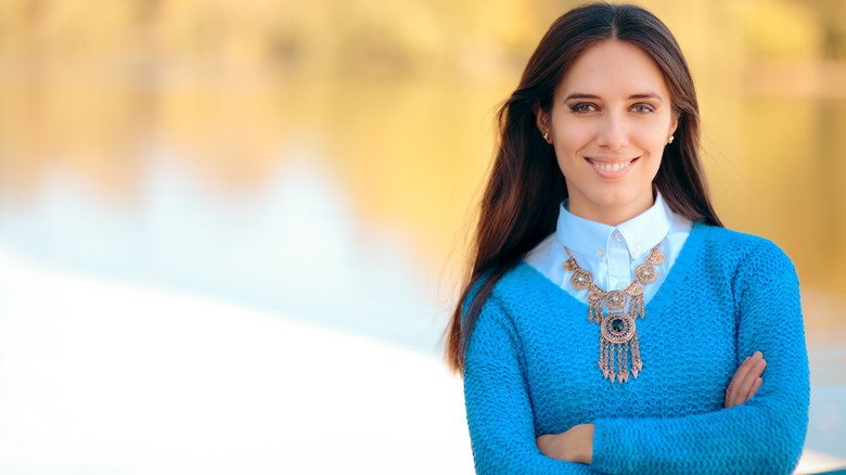 Woman wearing sweater with layered shirt