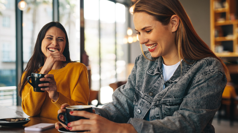 Friends laughing in a cafe