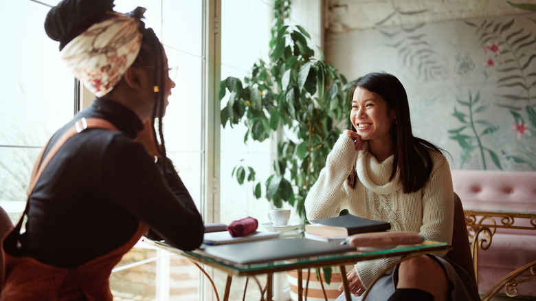 Two women talking at table