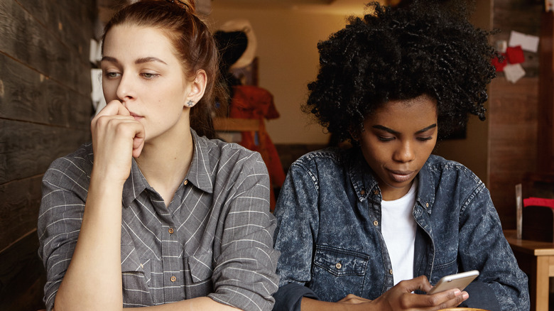 Two women staring away from each other