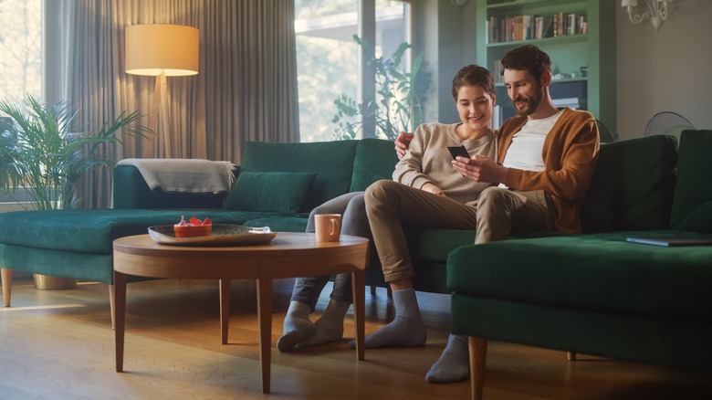 Couple looking at phone couch