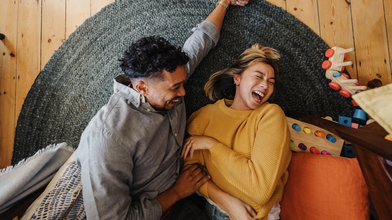 Couple laughing on floor