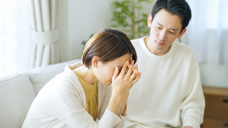 sad couple on couch