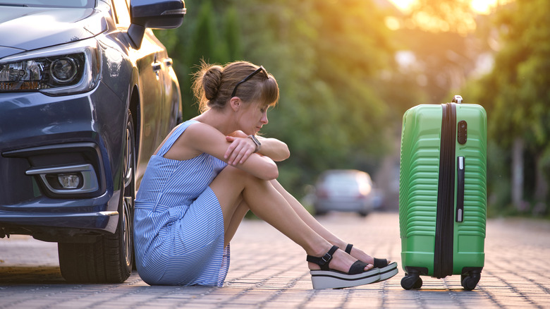 woman sitting with luggage