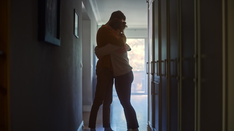 couple hugging in hallway