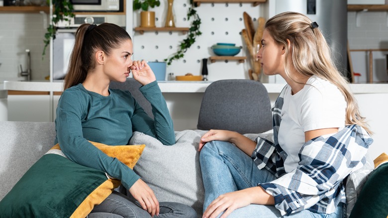 women talking on couch 