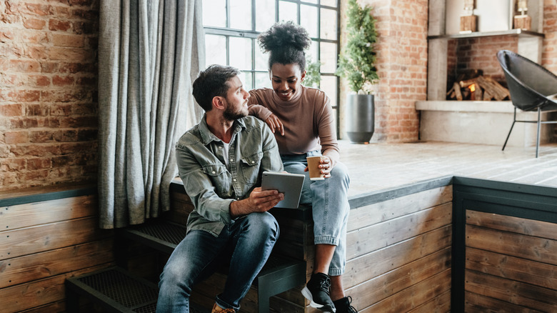 couple with tablet talking