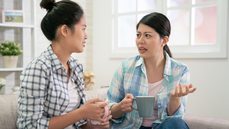 women with mugs talking