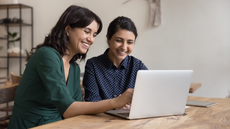 women looking at laptop together