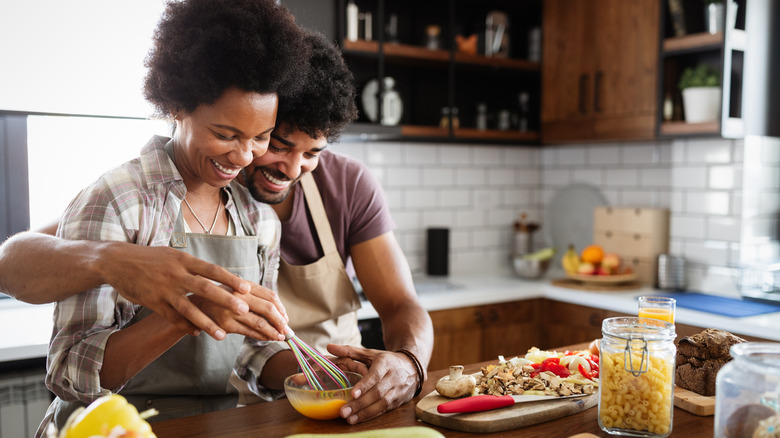 happy couple cooking