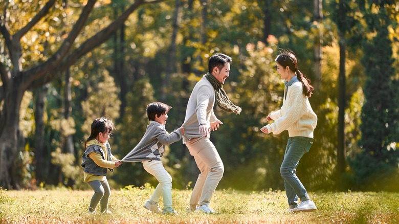 family outside playing in grass