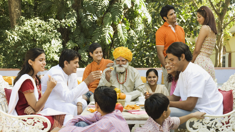 family eating at table outside 