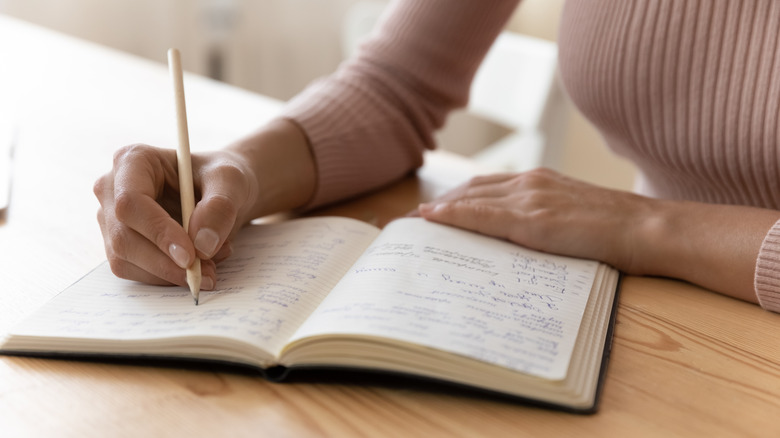 woman writing in journal