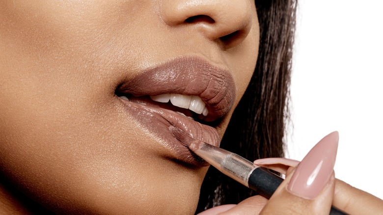 person applying lipstick