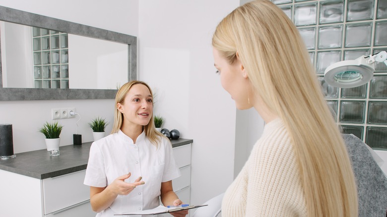 Woman talking to dermatologist