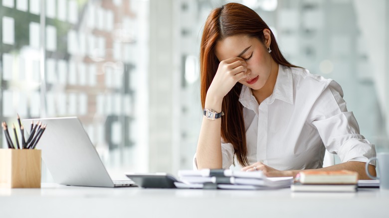 woman feeling stressed at work