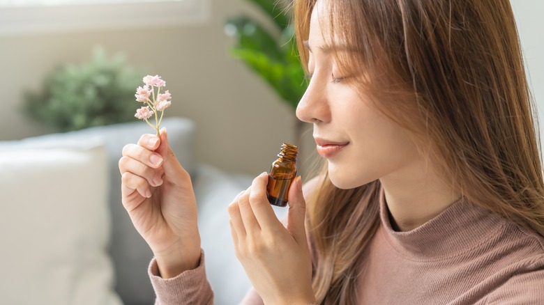 Woman smelling essential oils