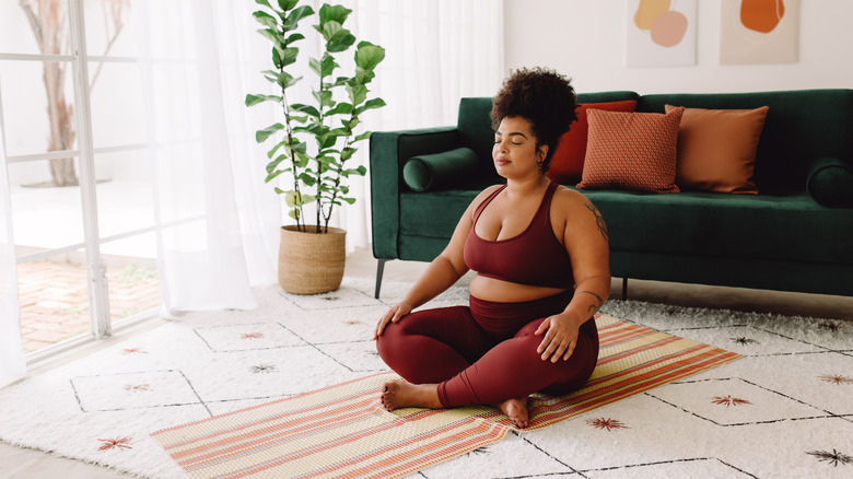 Woman meditating on yoga mat