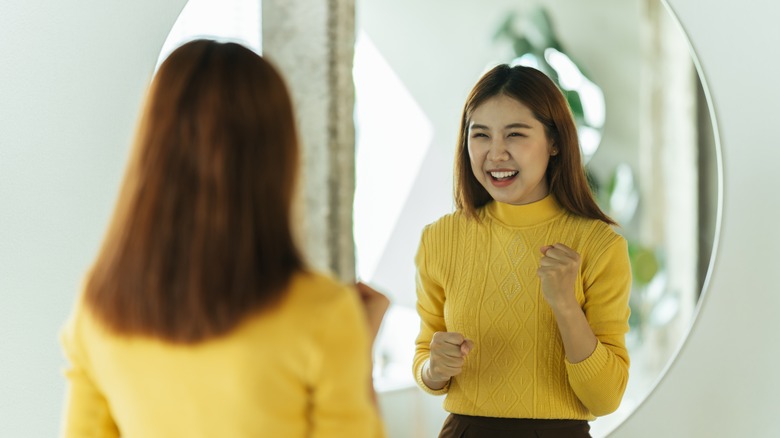 Practicing positive self-talk in mirror