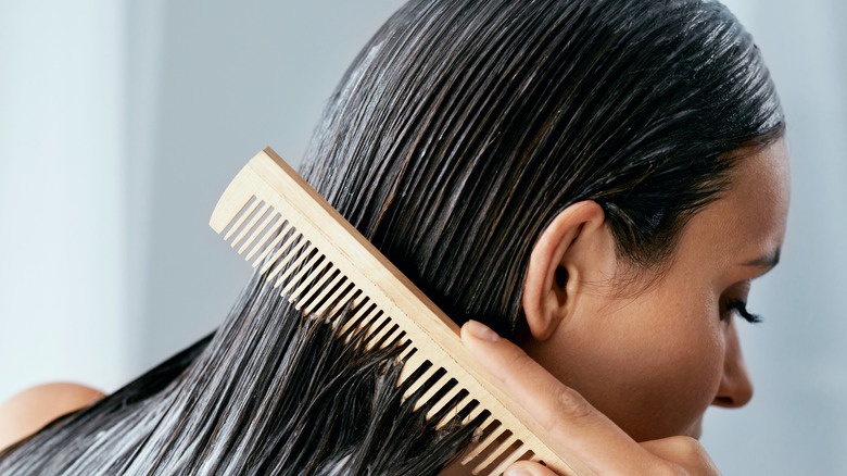 girl combing wet hair 