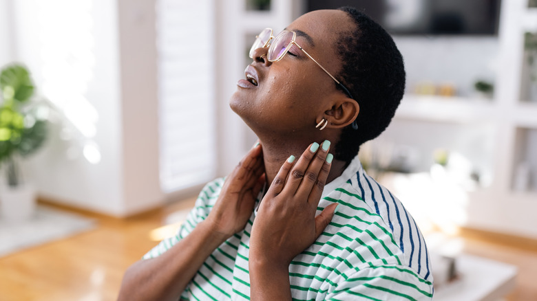 woman massaging her neck