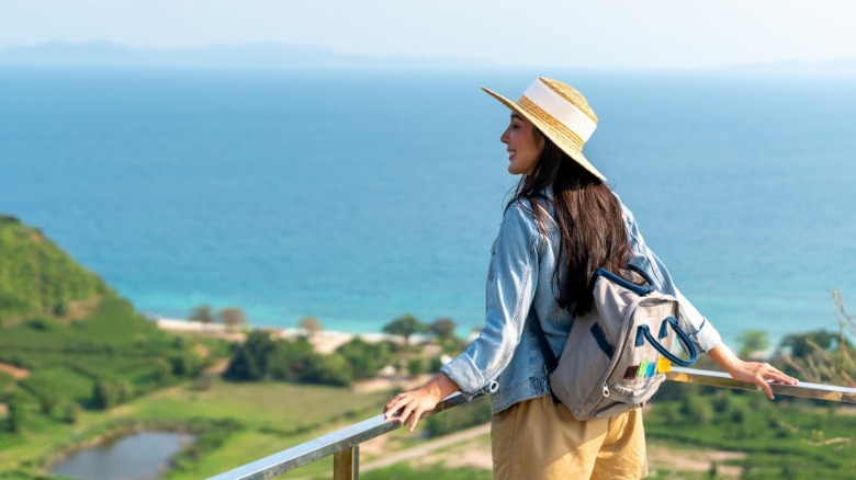 Woman smiling looking over balcony